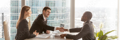 Cuadros en Lienzo Horizontal image african boss congratulate business partner with successful nego