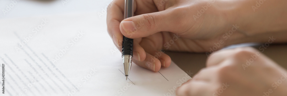 Closeup male hand holding pen put signature on official document - obrazy, fototapety, plakaty 