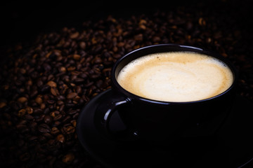 Black coffee cup with coffee beans