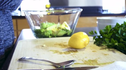 Poster - Slow motion. Slicing organic lemon on wood cutting board.