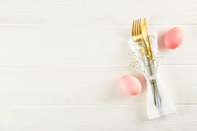 Table Setting Arrangement In Minimal Style With Easter Spring Holiday Attributes, Fork, Knife And Napkin. Background, Copy Space, Close Up, Flat Lay, Top View.