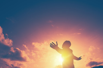 copy space of man rise hand up on top of mountain and sunset sky abstract background.