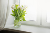 Fototapeta  - Bouquet of white tulip on windowsill. Copy space.