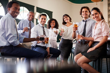 Portrait Of Business Colleagues Meeting For After Works Drinks In Bar