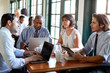 © Monkey Business - Business Team Having Informal Meeting Around Table In Coffee Shop