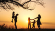 © alex_marina - Silhouettes of family spending time together in the meadow near during sunset