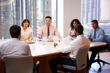 Wall Mural - Group Of Business Professionals Meeting Around Table In Modern Office