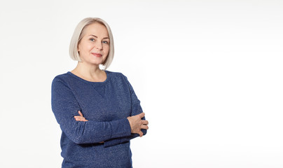 Wall Mural - attractive middle aged woman with folded arms on white background