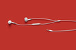 white earphone on red background, music