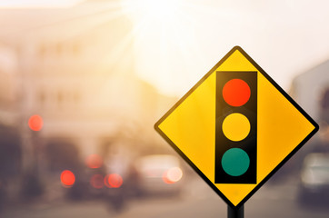 Wall Mural - Traffic light warning sign on blur traffic road with colorful bokeh light abstract background.