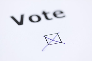 The word Vote - with mark in check box with pen - word blurred