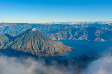 Wall Mural - Volcano San Pedro at Lake Atitlan in highlands of Guatemala - Village Santiago and San Pedro you can see -  Aerial View