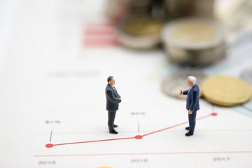 Miniature business men discuss on  line chart of business growth .Copy space and business concept. -Image.