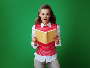 Wall Mural - surprised modern student holding opened yellow book