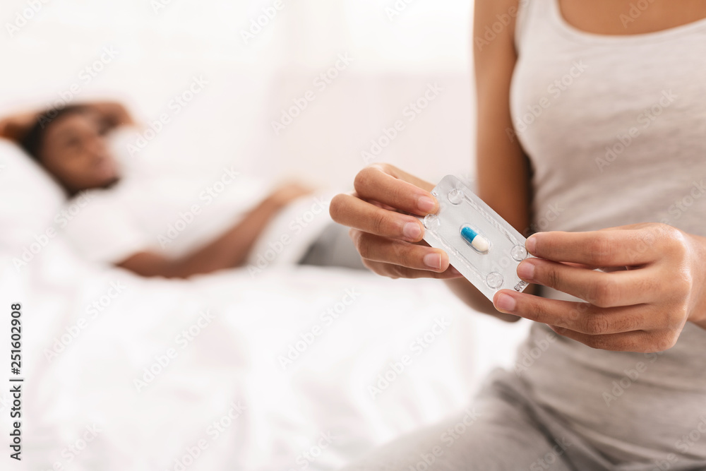 Black woman taking oral emergency contraceptive after sex - obrazy, fototapety, plakaty 