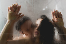 Selective Focus Of Passionate Naked Man Kissing Attractive Woman In Shower Cabin