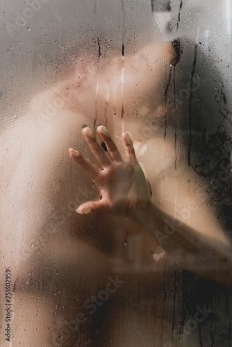 Cuadros en Lienzo selective focus of sexy couple hugging and kissing in shower cabin