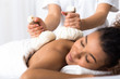 © Prostock-studio - Woman having herb compress massage in beauty spa