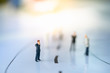 © Khongtham - Miniature people: Small businessman figures walking on the street. Business direction, search, leading concepts.