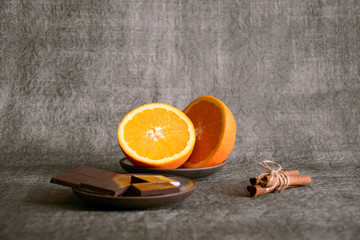 Dark chocolate, sliced orange and cinnamon sticks, close up, selective focus, copy space