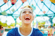 © Alliance - smiling fit woman in blue t-shirt in theme park having fun time