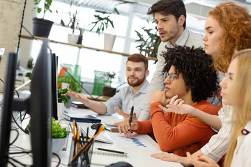 Poster - Millennial team working with new project on computer screen