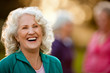 © Erickson Stock - Smiling senior woman standing outdoors