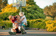 © Erickson Stock - Smiling father playing basketball with his young children.