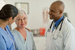 © Erickson Stock - Smiling doctor talking with patient in hospital