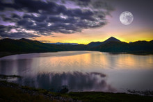 Landscape Lake River Nature With Full Moon Sunset Yellow And Purple Sky Dark Clouds Moving On Silhouette Mountain