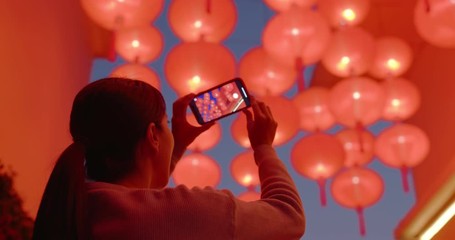 Poster - Woman take photo on cellphone under red lantern at night