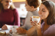 © Zoriana - Girl, smiling and holding cup of hot coffee at bright cafe.