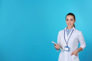 Poster - Young medical student with notebooks on color background. Space for text