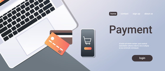 Poster - online shopping mobile application internet payment concept top angle view desktop smartphone laptop screen credit card office stuff horizontal copy space