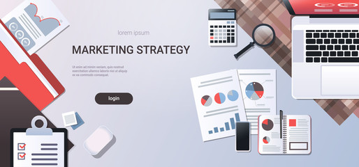 Poster - marketing strategy concept workplace desk top angle view laptop with paper documents report finance graph office stuff flat copy space horizontal
