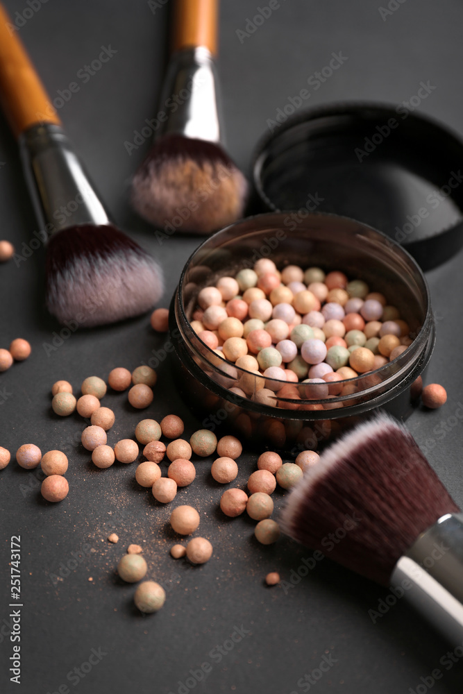 Makeup brushes and powder on table