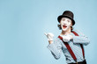 © rh2010 - Emotional pantomime with white facial makeup showing empty space on the blue background, advertising something