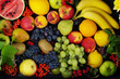 A variety of fruits on the dishes on the table. Grapes, peaches, bananas, kiwi, apples, lemon, orange, pomegranate, pears. Close-up.