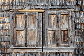 Weathered wIndow shutters of an old abandoned farmhouse