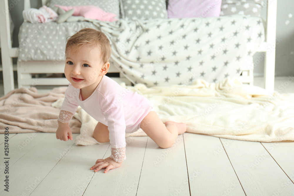 Cute baby girl crawling on floor