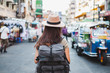 © Nattakorn - Back view Asian woman tourist backpacker travel in Khao San road, Bangkok, Thailand