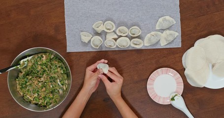 Canvas Print - Top view of Woman make of chinese meat dumpling at home