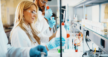 Young students of chemistry working in laboratory