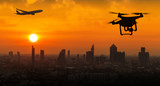 Fototapeta  - Silhouette of drone flying near an airport with airplane, no drone zone concept
