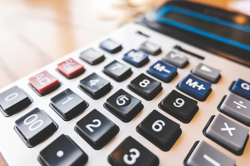 Calculator on wood background.