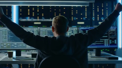 Fototapete - IT Specialist Working on Personal Computer with Monitors Showing Coding Language Program, He Celebrates His Success by Doing YES Gesture. Technical Room of Data Center. Back to the Camera Shot