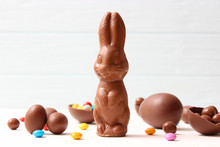  Easter Composition With Chocolate Eggs And Chocolate Rabbit On Wooden Background, Place For Text 