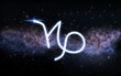 astrology and horoscope - capricorn zodiac sign over dark night sky with stars and galaxy background
