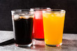 Colorful soft drinks for summer on gray background