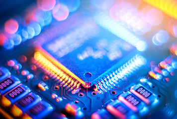 Computer Microchips and Processors on Electronic circuit board. Abstract technology microelectronics concept background. Macro shot, shallow focus.